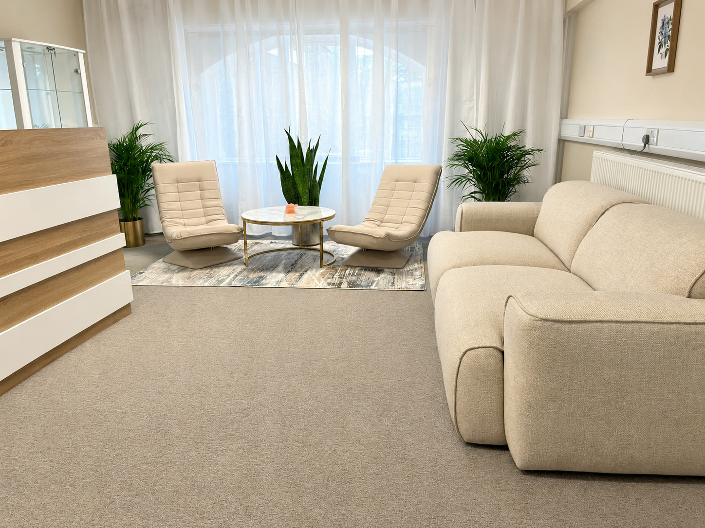 The reception lounge from the desk: sofa, chairs and the arched window