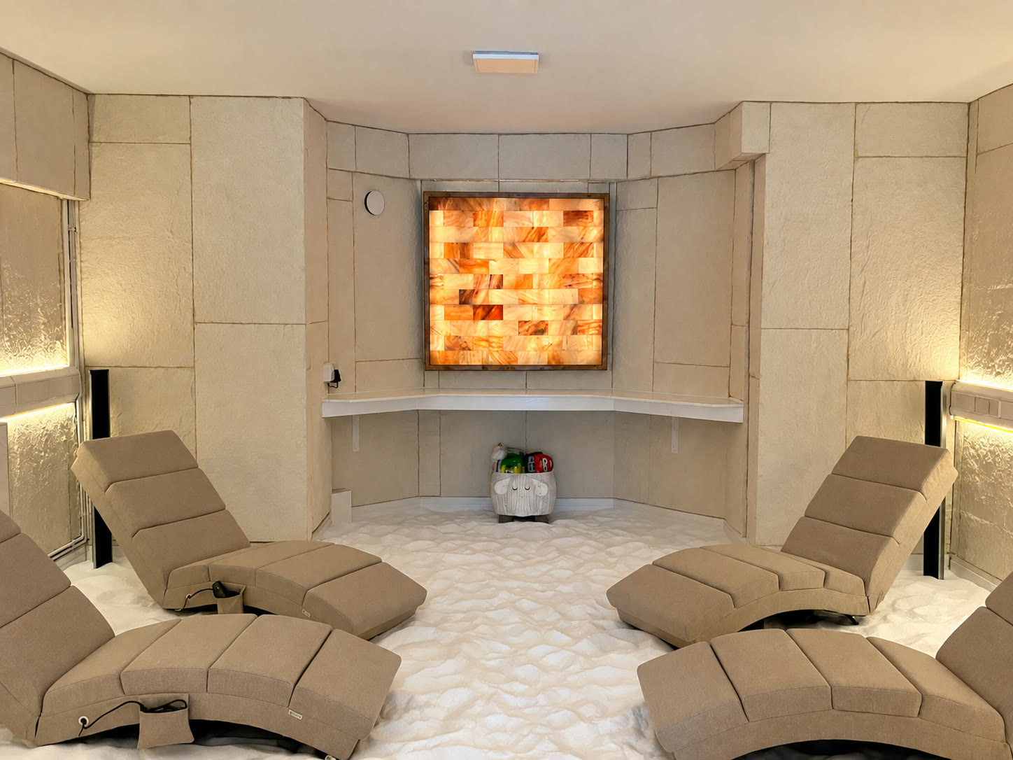 Six recliners around the room, all facing the glowing salt panel