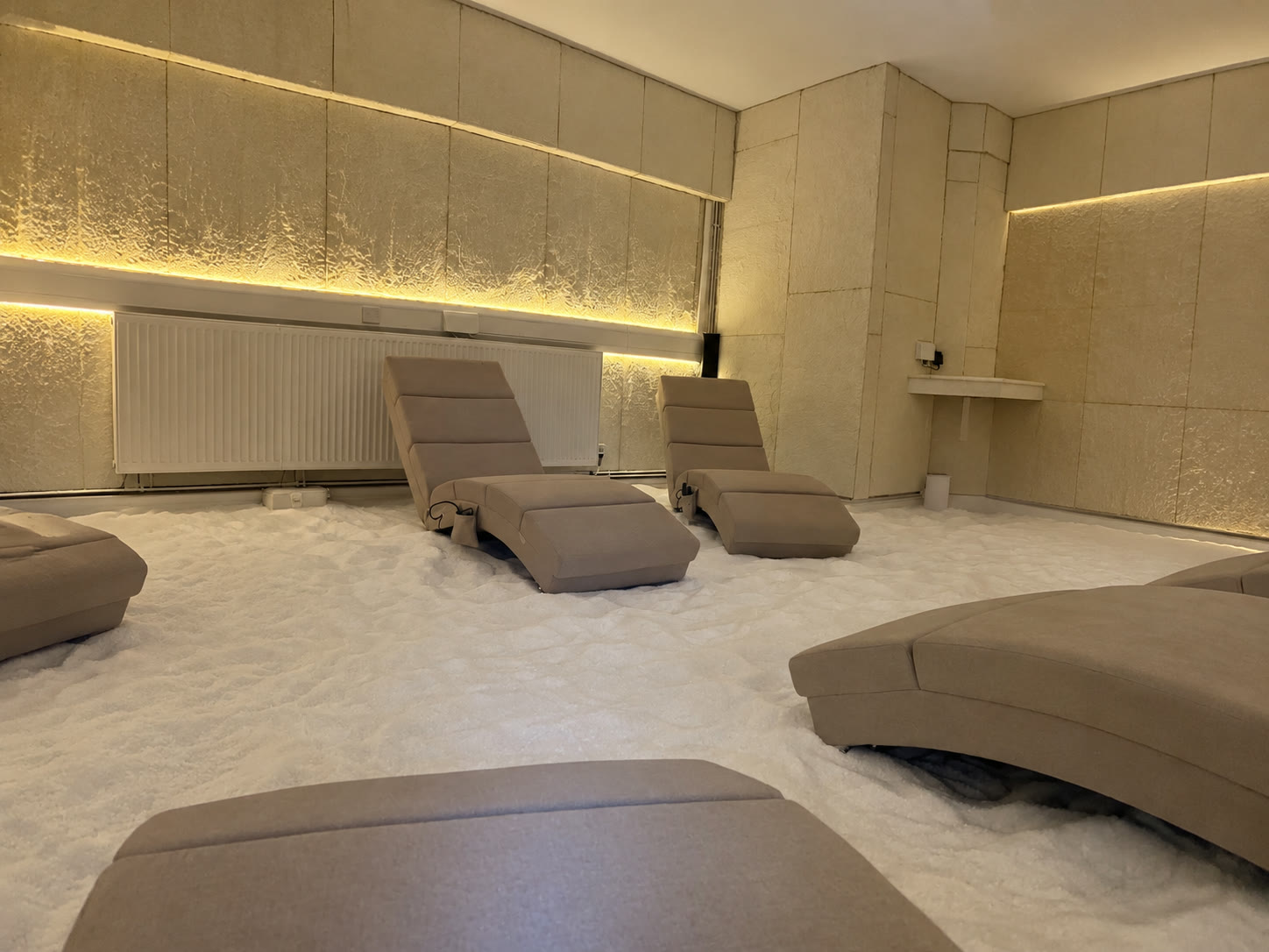 Recliners along the lit salt wall, seen from a low angle