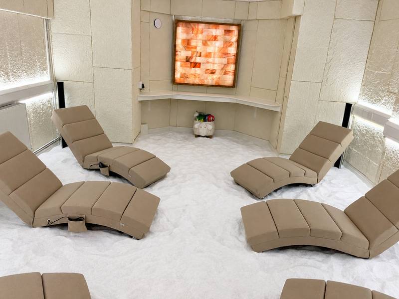Recliners facing the glowing Himalayan salt panel